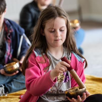 Sound Bath Girl playing instrument